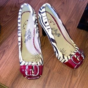 Zebra print shoes with red buckle